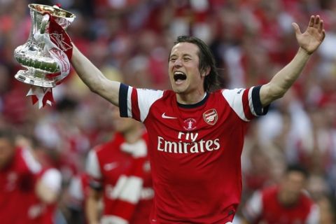 Arsenal's Tomas Rosicky celebrates with the trophy after their win against Hull City at the end of their English FA Cup final soccer match at Wembley Stadium in London, Saturday, May 17, 2014. (AP Photo/Sang Tan)
