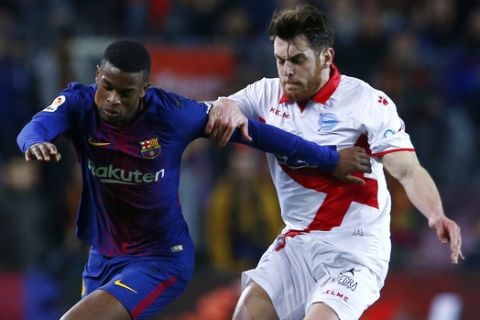 FC Barcelona's Semedo, left, duels for the ball against Alaves' Ibai Gomez during the Spanish La Liga soccer match between FC Barcelona and Alaves at the Camp Nou stadium in Barcelona, Spain, Sunday, Jan. 28, 2018. (AP Photo/Manu Fernandez)