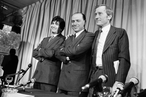 Italian television network magnate Sylvio Berlusconi, center, is surrounded by the two others responsible for the new French private non-coded TV channel. From left to right are: French Chrisophe Riboud of the advertising department, Sylvio Berlusconi and French Jerome Seydoux, chairman of the new television network, during a press conference to present the new channel, Frances fifty on Friday, Nov. 22, 1985 in Paris. (AP Photo/Herve Merliac)