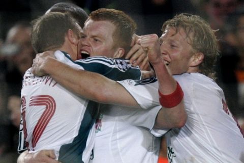 Liverpool's John Arne Riise, centre, celebrates scoring against Barcelona with Craig Bellamy, left, and Dirk Kuyt, right, in the Champions League first knockout round, first-leg soccer match at the Camp Nou Stadium, Barcelona, Spain, Wednesday Feb. 21, 2007. (AP Photo/Dave Thompson)