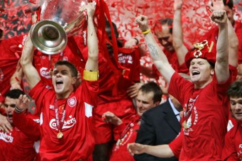 Liverpool's captain Steven Gerrard, left, holds the trophy as teammate John Arne Riise celebrates after the UEFA Champions League Final between AC Milan and Liverpool at the Ataturk Olympic Stadium in Turkey, Istanbul Wednesday May 25, 2005. Liverpool won 3-2 on penalties after the match finished 3-3 after extra time.  (AP Photo/Thomas Kienzle)