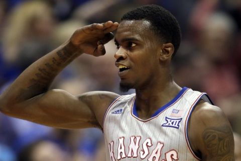 Kansas guard Lagerald Vick (24) salutes after a three-point basket during the second half of an NCAA college basketball game against Vermont in Lawrence, Kan., Monday, Nov. 12, 2018. Vick scored 32 points in the game. Kansas defeated Vermont 84-68. (AP Photo/Orlin Wagner)
