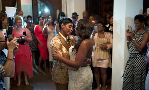NBA referee Violet Palmer, center left, and her partner Tanya Stine dance during their wedding reception on Friday, Aug. 1, 2014, in Los Angeles. In an interview with The Associated Press, Palmer says she came out to her fellow NBA referees in 2007. (AP Photo/Jae C. Hong)