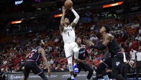 Brooklyn Nets' D'Angelo Russell (1) shoots over Miami Heat's Derrick Jones Jr. (5), Josh Richardson (0) and Hassan Whiteside, right, during the first half of an NBA basketball game, Tuesday, Nov. 20, 2018, in Miami. (AP Photo/Lynne Sladky)