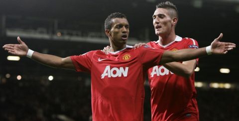 Manchester United's Nani, left, is congratulated by team mate Federico Macheda after scoring a goal against Bursaspor during their Champions League group C soccer match at Old Trafford, Manchester, England, Wednesday, Oct. 20, 2010. (AP Photo/Jon Super)