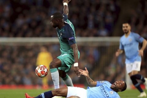Manchester City's Raheem Sterling, down, and Tottenham Hotspur's Moussa Sissoko, during the Champions League quarterfinal, second leg, soccer match between Manchester City and Tottenham Hotspur at the Etihad Stadium in Manchester, England, Wednesday, April 17, 2019. (Mike Egerton / PA via AP)