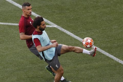 Liverpool forward Mohamed Salah, right controls the ball in front of Dejan Lovren during a training session at the Wanda Metropolitano stadium in Madrid, Friday May 31, 2019. English Premier League teams Liverpool and Tottenham Hotspur are preparing for the Champions League final which takes place in Madrid on Saturday night. (AP Photo/Armando Franca)