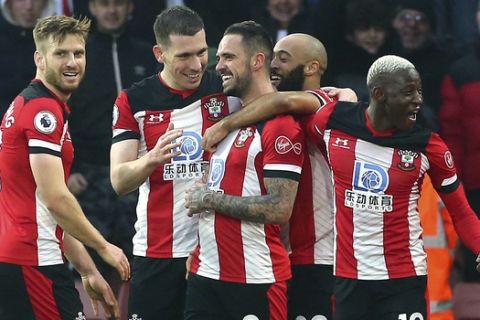 Southampton's Danny Ings, centre, celebrates with teammates after scoring his side's first goal during the English Premier League soccer match between Southampton and Tottenham Hotspur at St Mary's Stadium, in Southampton, England, Wednesday Jan. 1, 2020. (Mark Kerton/PA via AP)