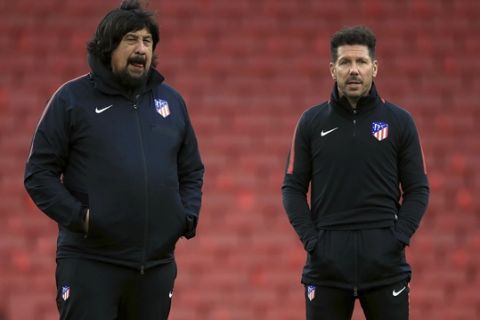 Atletico Madrid manager Diego Simeone, right, and assistant coach German Burgos look on during a soccer squad training session at Emirates Stadium in London, Wednesday, April 25, 2018. Atletico Madrid faces Arsenal in a Europa League match on Thursday.  (Adam Davy/PA Wire)