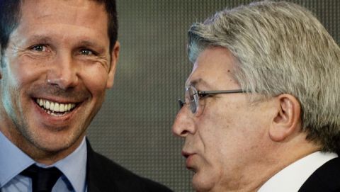 Atletico Madrid coach Diego Simeone, left, smiles while Atletico de Madrid president Enrique Cerezo speaks with him after a press conference at the Vicente Calderon stadium in Madrid, Spain, Tuesday, March 24, 2015. The former Argentina and Atletico midfielder, who took over as coach in December 2011, has renewed his contract with the Spanish champions for another five seasons, keeping him at the club until 2020. (AP Photo/Daniel Ochoa de Olza)