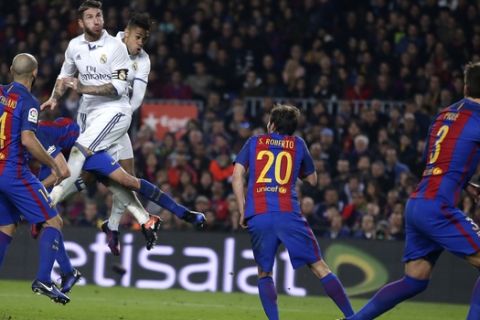 Real Madrid's Sergio Ramos, top left, and Mariano Diaz jump to head the ball during the Spanish La Liga soccer match between FC Barcelona and Real Madrid at the Camp Nou in Barcelona, Spain, Saturday, Dec. 3, 2016. (AP Photo/Manu Fernandez)