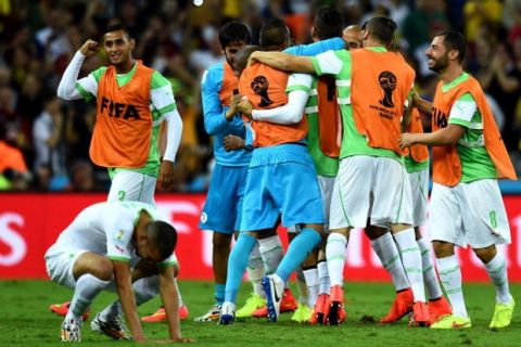 CURITIBA, BRAZIL - JUNE 26: Algeria celebrate scoring their team's first goal during the 2014 FIFA World Cup Brazil Group H match between Algeria and Russia at Arena da Baixada on June 26, 2014 in Curitiba, Brazil.  (Photo by Shaun Botterill - FIFA/FIFA via Getty Images)