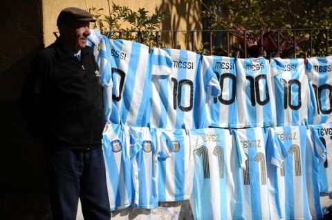 A peddler offers Argentine football team striker Lionel Messi's #10 jerseys and Tevez's #11s at a street near Colon stadium in Santa Fe, Argentina on July 6, 2011. Argentina faces Colombia tonight for the group A of the Copa America 2011.  AFP PHOTO/Rodrigo BUENDIA (Photo credit should read RODRIGO BUENDIA/AFP/Getty Images)