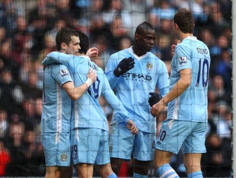 MANCHESTER, ENGLAND - MARCH 03:  Mario Balotelli of Manchester City celebrates with Edin Dzeko after scoring the second goal during the Barclays Premier League match between Manchester City and Bolton Wanderers at the Etihad Stadium on March 3, 2012 in Manchester, England.  (Photo by Alex Livesey/Getty Images)