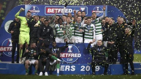 Celtic celebrate with the trophy after the Scottish Cup soccer Final between Celtic and Rangers at Hampden Park, Glasgow, Scotland, Sunday, Dec. 8, 2019. (Jeff Holmes/PA via AP)