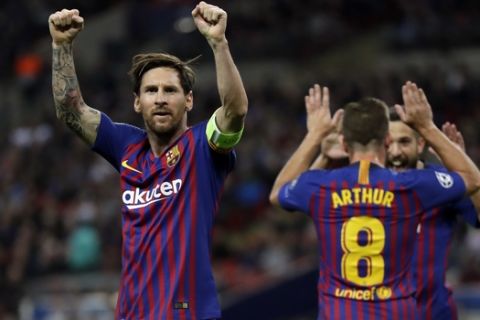 Barcelona forward Lionel Messi, left, celebrates after scoring his side's third goal during the Champions League Group B soccer match between Tottenham Hotspur and Barcelona at Wembley Stadium in London, Wednesday, Oct. 3, 2018. (AP Photo/Kirsty Wigglesworth)