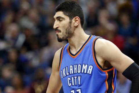 FILE - In this April 11, 2017, file photo, Oklahoma City Thunder's Enes Kanter, of Turkey, looks on during a break in the second half of an NBA basketball game against the Minnesota Timberwolves in Minneapolis. Kanter is returning to the United States after being detained in a Romanian airport. Romanian Border Police spokesman Fabian Badila confirmed to The Associated Press that the player left Romania for the United States via London. Kanter, who is from Turkey, said in a video Saturday morning, May 20, 2017, on his Twitter account that the Turkish embassy canceled his passport and he'd been detained for several hours at a Romanian airport. (AP Photo/Jim Mone, File)