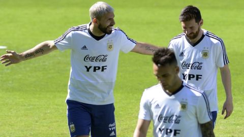 Argentina's Sergio Aguero, left, talks with teammate Lionel Messi during a practice session of the national soccer team in Belo Horizonte, Brazil, Tuesday, June 18, 2019. Argentina will face Paraguay tomorrow in a Copa America Group B soccer match. (AP Photo/Eugenio Savio)
