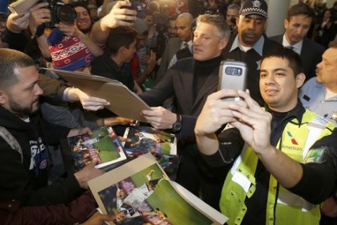 German soccer star Bastian Schweinsteiger, center, signs autographs after arriving at O'Hare International Airport Tuesday, March 28, 2017, in Chicago, after being acquired by the MLS Chicago Fire soccer team from Manchester United. (AP Photo/Charles Rex Arbogast)