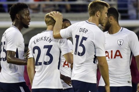 After scoring a goal against Paris Saint-Germain, Tottenham's Christian Eriksen (23) is surrounded by teammates including Joshua Onomah, left, Eric Dier (15) and Cameron Carter-Vickers (38) as they celebrate during an International Champions Cup soccer match, Saturday, July 22, 2017, in Orlando, Fla. (AP Photo/John Raoux)