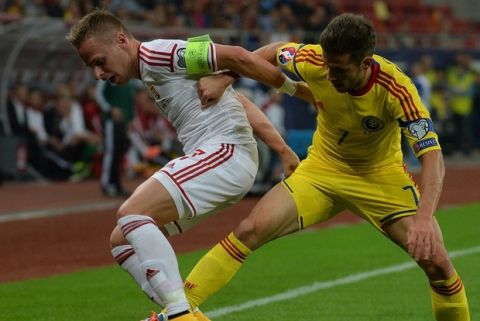 Romania's midfielder Alexandru Chipciu (R) and Hungary's captain and midfielder Balazs Dzsudzsak vie for the ball during the Euro 2016 Group F qualifying football match Romania vs Hungary in Bucharest, Romania on October 11, 2014.  AFP PHOTO / DANIEL MIHAILESCU        (Photo credit should read DANIEL MIHAILESCU/AFP/Getty Images)