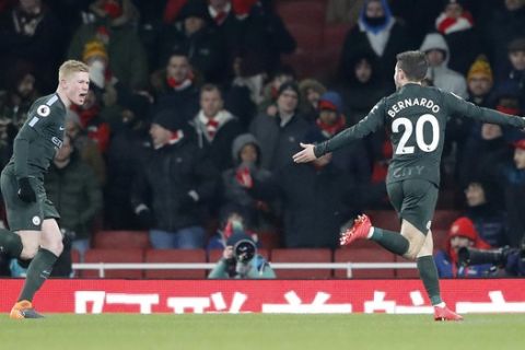 Manchester City's Bernardo Silva, right, celebrates after scoring the opening goal during the English Premier League soccer match between Arsenal and Manchester City at the Emirates stadium in London, Thursday, March 1, 2018.(AP Photo/Frank Augstein)