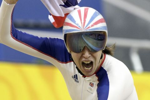 FILE  - This is a Sunday, Aug. 17, 2008 file photo of  Britain's Rebecca Romero as she waves a national flag after winning the gold medal of the Track Cycling Women's Individual Pursuit event, at the Beijing 2008 Olympics in Beijing. Romero, one of the few athletes to win an Olympic medal in two different sports, has left the British  Olympic cycling program. Romero said in a statement Monday Oct. 10, 2011 that she feels she is "no longer on a pathway which will see me fulfil my Olympic ambition to win a second gold medal." The 31-year-old cyclist won the gold medal in the individual pursuit at the Beijing Games, four years after she took a silver medal in rowing. She is one of only two women in history to win a medal in two different sports. (AP Photo/Ricardo Mazalan, File)