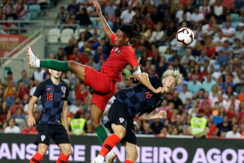 Portugal's Gelson Martins jumps for the ball with Croatia's Tin Jedvaj, right, during the international friendly soccer match between Portugal and Croatia at the Algarve stadium, outside Faro, Portugal, Thursday, Sept. 6, 2018. (AP Photo/Armando Franca)