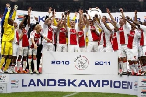 Ajax Amsterdam soccer players celebrate with the trophy after winning the Dutch soccer League at the Arena stadium in Amsterdam, The Netherlands, Sunday May 15, 2011. Ajax won the last match of the season against FC Twente, 2-0. (AP Photo/Bas Czerwinski)