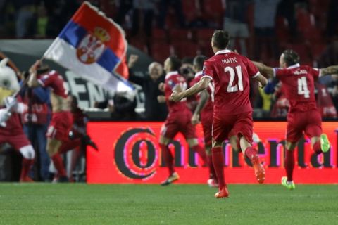 Serbia's Aleksandar Prijovic, left, is chased by his teammates after scoring the first goal of his team during their World Cup Group D qualifying soccer match between Serbia and Georgia at the Rajko Mitic stadium in Belgrade, Serbia, Monday, Oct. 9, 2017. (AP Photo/Darko Vojinovic)
