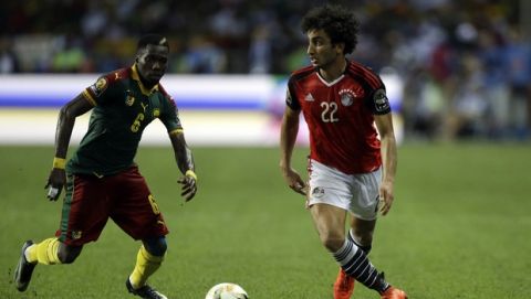 Egypt's Amr Warda, right, controls the ball in front of Cameroon's Ambroise Oyongo during the African Cup of Nations final soccer match between Egypt and Cameroon at the Stade de l'Amitie, in Libreville, Gabon, Sunday, Feb. 5, 2017. (AP Photo/Sunday Alamba)