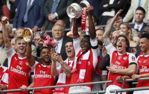Arsenal's Danny Welbeck lifts the trophy after winning the English FA Cup final soccer match between Arsenal and Chelsea at Wembley stadium in London, Saturday, May 27, 2017. Arsenal won 2-1. (AP Photo/Kirsty Wigglesworth)