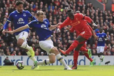 Liverpool's Sadio Mane, right, scores his side's first goal, during the English Premier League soccer match between Liverpool and Everton, at Anfield, in Liverpool, England, Saturday April 1, 2017. (Peter Byrne/PA via AP)