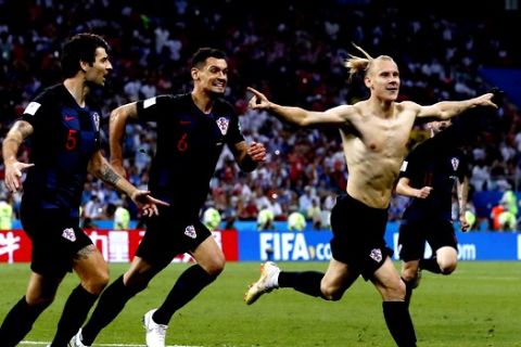 Croatia's Domagoj Vida, right, celebrates with his teammates after scoring his side's second goalduring the quarterfinal match between Russia and Croatia at the 2018 soccer World Cup in the Fisht Stadium, in Sochi, Russia, Saturday, July 7, 2018. (AP Photo/Manu Fernandez)
