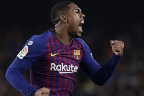 Barcelona forward Malcom celebrates scoring his side's first goal during the Copa del Rey semifinal first leg soccer match between FC Barcelona and Real Madrid at the Camp Nou stadium in Barcelona, Spain, Wednesday Feb. 6, 2019. (AP Photo/Emilio Morenatti)