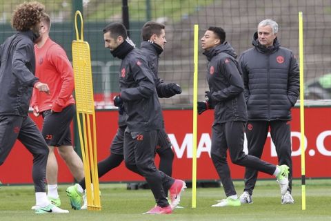 Manchester United manager Jose Mourinho, right, attends a training session at the Aon Training Complex, Carrington, England, Wednesday, April 12, 2017. Manchester United will play RSC Anderlecht in a Europa League soccer match on Thursday. (Martin Rickett/PA via AP)