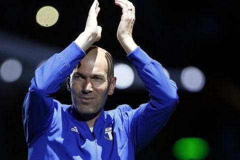 Former Real Madrid head coach Zinedine Zidane acknowledges applause as he arrives to a charity soccer match between members of the 1998 World Cup winning French team and a team of international veteran players who were also involved in the same tournament, at the U Arena in Nanterre, north of Paris, France, Tuesday, June 12, 2018. (AP Photo/Thibault Camus)