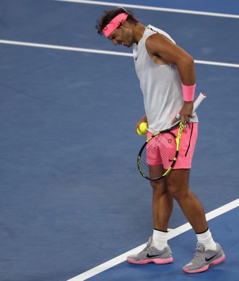 Spain's Rafael Nadal reacts during his quarterfinal loss to Croatia's Marin Cilic at the Australian Open tennis championships in Melbourne, Australia, Tuesday, Jan. 23, 2018. Nadal is out of the Australian Open after retiring in the fifth set of their quarterfinal match with an upper right leg injury.(AP Photo/Ng Han Guan)