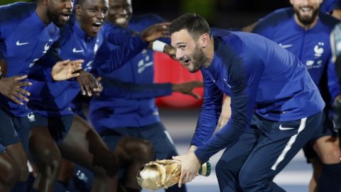 France's Hugo Lloris, center, and teammates celebrate with the World Cup trophy during a ceremony after the UEFA Nations League soccer match between France and The Netherlands at the Stade de France stadium in Saint-Denis, outside Paris, France, Sunday, Sept. 9, 2018. (AP Photo/Christophe Ena)