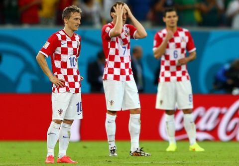 RECIFE, BRAZIL - JUNE 23:  A dejected Luka Modric, Ivan Rakitic and Dejan Lovren of Croatia react after a 3-1 defeat to Mexico in the 2014 FIFA World Cup Brazil Group A match between Croatia and Mexico at Arena Pernambuco on June 23, 2014 in Recife, Brazil.  (Photo by Michael Steele/Getty Images)