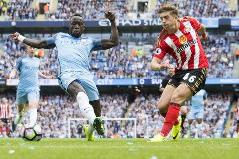Manchester City's Bacary Sagna, left, attempts to block a cross by Sunderland's Lynden Gooch during the English Premier League soccer match between Manchester City and Sunderland at the Etihad Stadium in Manchester, England, Saturday Aug. 13, 2016. (AP Photo/Jon Super)  