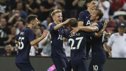 Tottenham's Harry Kane celebrates with his teammates after scoring a goal during the International Champions Cup soccer match between Juventus and Tottenham Hotspur in Singapore, Sunday, July 21, 2019. (AP Photo/Danial Hakim)