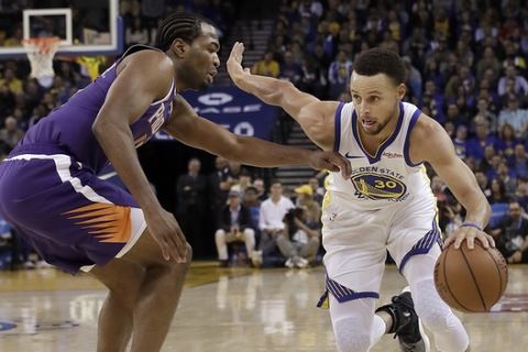 Golden State Warriors guard Stephen Curry, right, drives against Phoenix Suns forward TJ Warren during the second half of an NBA basketball game in Oakland, Calif., Monday, Oct. 22, 2018. (AP Photo/Jeff Chiu)