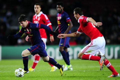 FC Barcelona's Lionel Messi from Argentina vies for the ball against Benfica's Nemanja Matic from Serbia during a group G Champions League soccer match against Benfica at the Camp Nou stadium in Barcelona, Spain, Wednesday, Dec. 5, 2012. (AP Photo/Manu Fernandez)