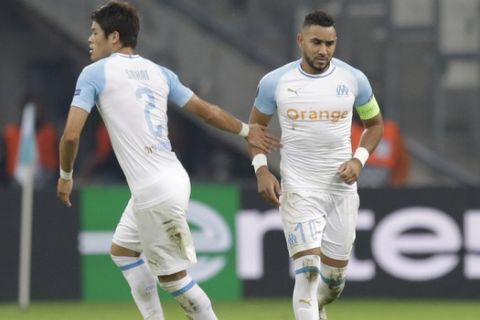 Marseille's Dimitri Payet, right, celebrates with his teammate Hiroki Sakai after scoring during the Europa League, Group H soccer match between Marseille and Lazio at the Velodrome Stadium in Marseille, France,Thursday, Oct. 25, 2018. (AP Photo/Claude Paris)
