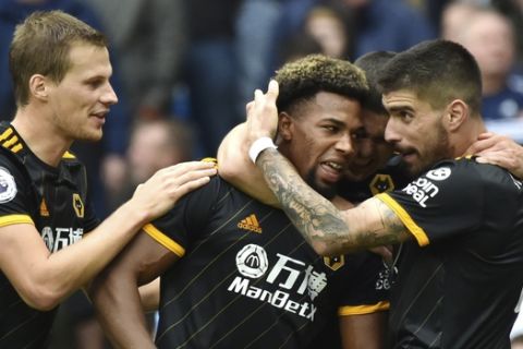 Wolverhampton Wanderers' Adama Traore, centre, celebrates with teammates after scoring during the English Premier League soccer match between Manchester City and Wolverhampton Wanderers at Etihad stadium in Manchester, England, Sunday, Oct. 6, 2019. (AP Photo/Rui Vieira)