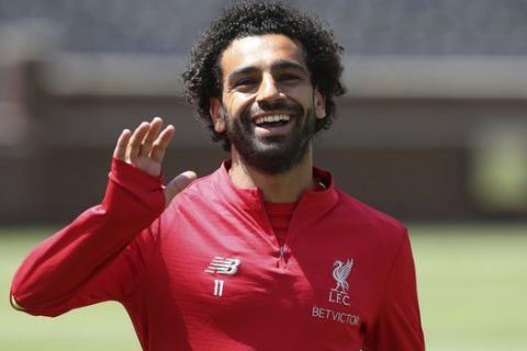 Liverpool forward Mohamed Salah waves to fans before a training session, Friday, July 27, 2018, in Ann Arbor, Mich. Liverpool FC will play Manchester United on Saturday in an International Champions Cup tournament soccer match. (AP Photo/Carlos Osorio)
