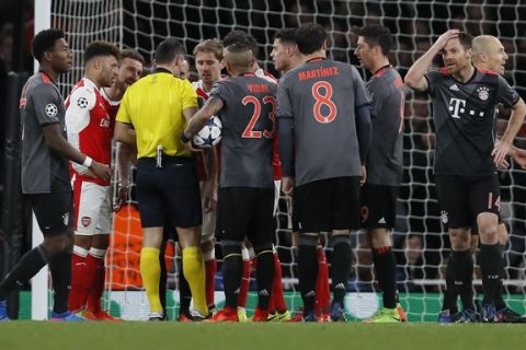 Players argue with referee during the Champions League round of 16 second leg soccer match between Arsenal and Bayern Munich at the Emirates Stadimum in London, Tuesday, March 7, 2017. (AP Photo/Kirsty Wigglesworth)