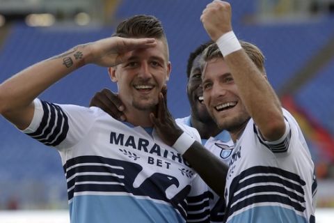 Lazio's Sergej Milinkovic-Savic, left, celebrates with his teammates Felipe Caicedo, center, and Ciro Immobile, after scoring his side' third goal, during a Serie A soccer match between Lazio and Genoa at Rome's Olympic stadium, Sunday, Sept. 23, 2018. (AP Photo/Alessandra Tarantino)