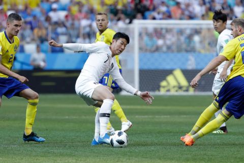 South Korea's Son Heung-min, center, vies for the ball during the group F match between Sweden and South Korea at the 2018 soccer World Cup in the Nizhny Novgorod stadium in Nizhny Novgorod, Russia, Monday, June 18, 2018. (AP Photo/Lee Jin-man)